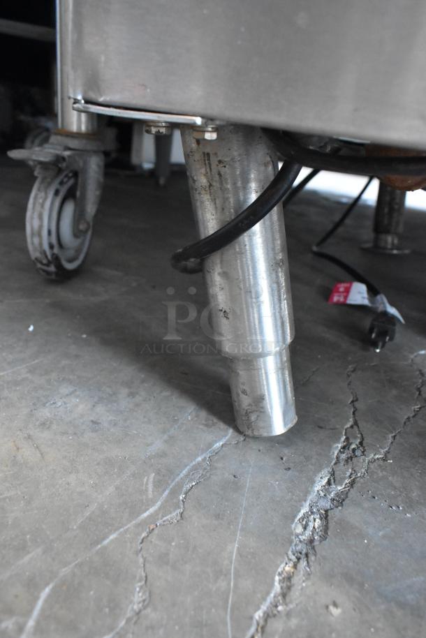 Vulcan VSX24G steam cabinet leg with caster, stainless steel, visible wear, commercial natural gas model, 200,000 BTU.