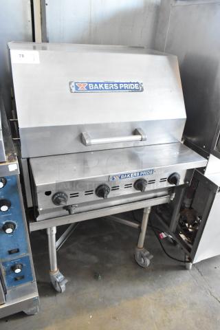 Bakers Pride CBBQ30S stainless steel propane charbroiler grill on commercial casters, featuring multiple controls and branded cover.