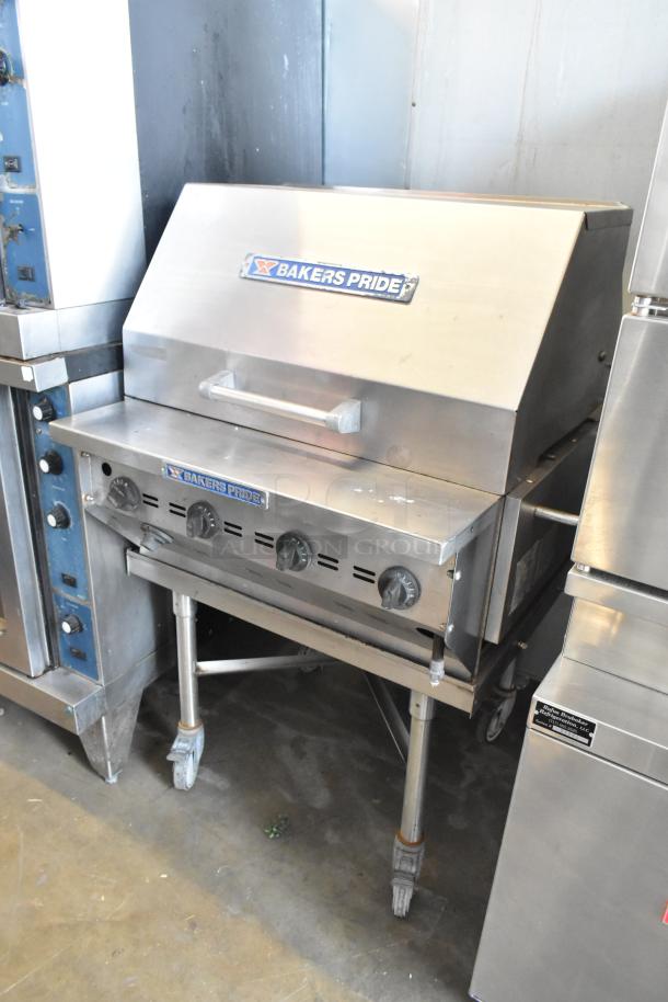 Bakers Pride CBBQ30S stainless steel charbroiler grill, propane gas, with cover and commercial casters, in used condition.