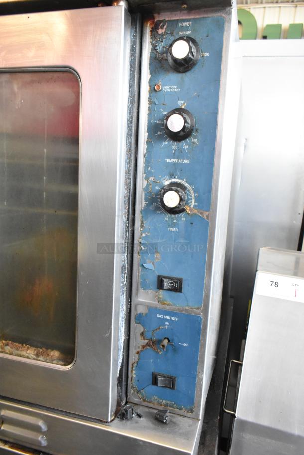 Duke stainless steel commercial full-size convection oven with view-through doors, metal racks, and thermostatic controls. Visible wear.