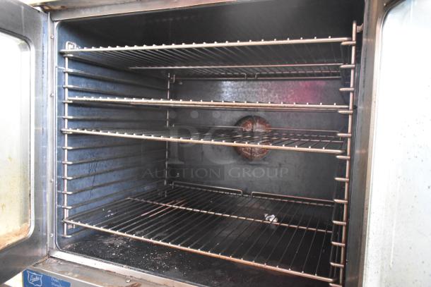 Duke stainless steel commercial convection oven, view-through doors, metal racks, thermostatic controls, good condition.