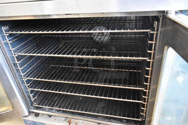 Duke stainless steel convection oven with view-through doors, metal racks, and thermostatic controls. Good condition.
