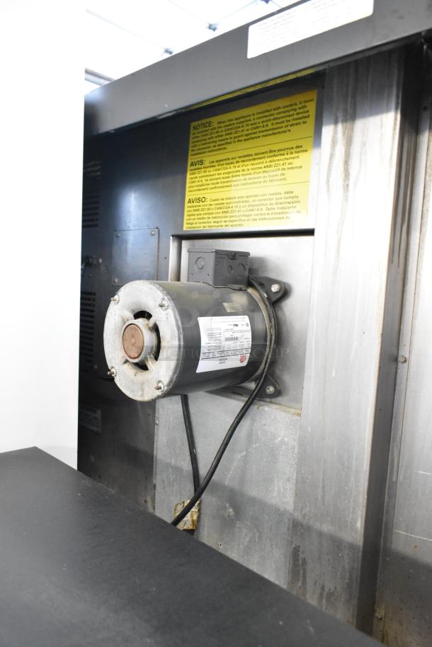 Duke stainless steel convection oven part; notice and warning labels; metal components; wiring visible.