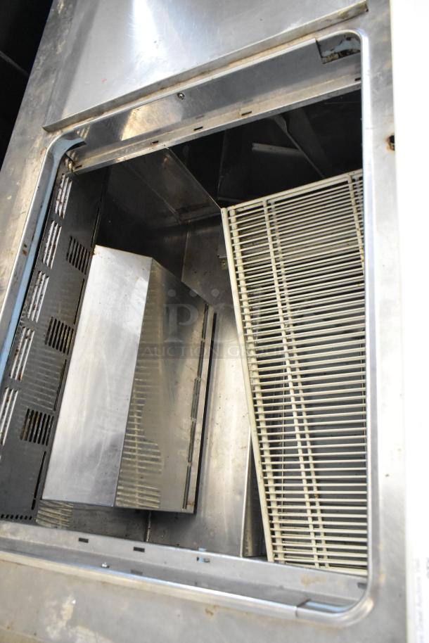 Delfield 4460N-24M stainless steel commercial prep table interior view, showing shelves and venting, 115 volts, 1 phase.