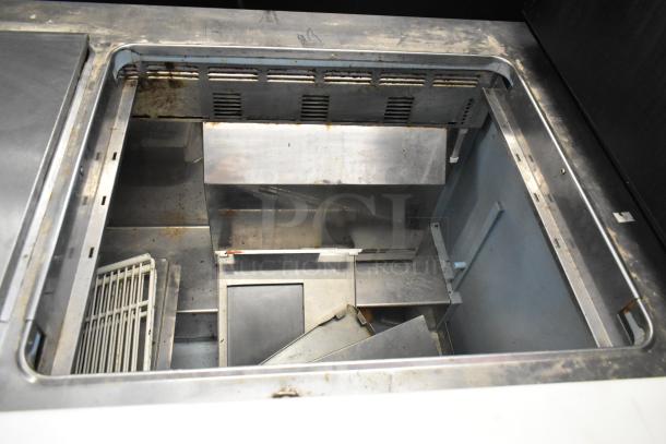 Delfield 4460N-24M stainless steel prep table, interior view, showing storage area and minimal wear. 115V, 1 phase.