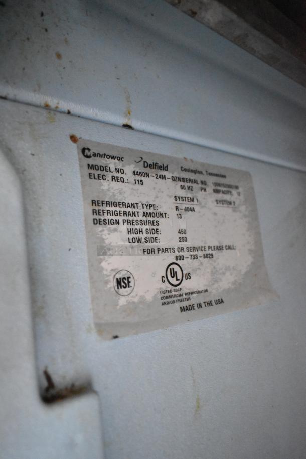 Label on Delfield 4460N-24M stainless steel prep table, showing model, electrical details, and refrigerant info. Made in USA.