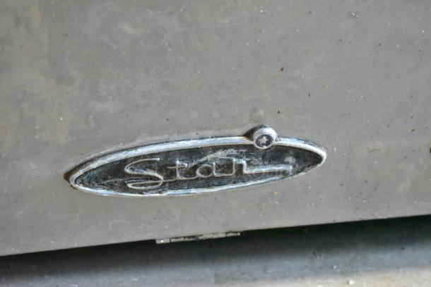 Star Stainless Steel Flat Top Griddle in used condition. Features a smooth cooking surface and branded logo. Ideal for commercial use.