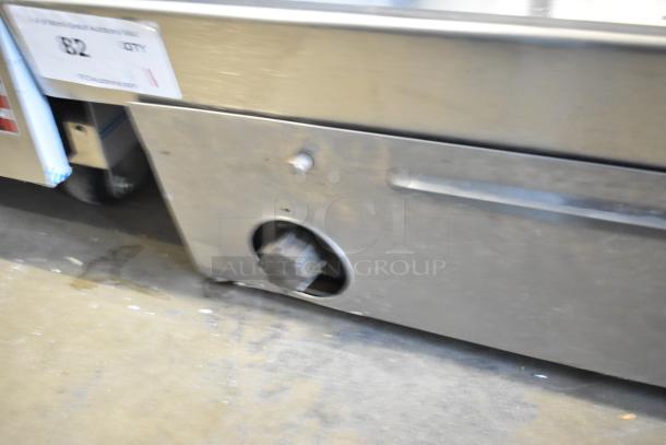 Star stainless steel commercial countertop flat top griddle, used condition, control knob visible, auction tag 82 displayed.