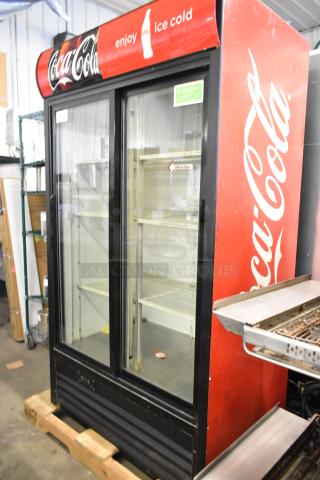 True GDM-37EM metal commercial cooler, two glass doors, Coca-Cola branding, poly coated racks, used condition.