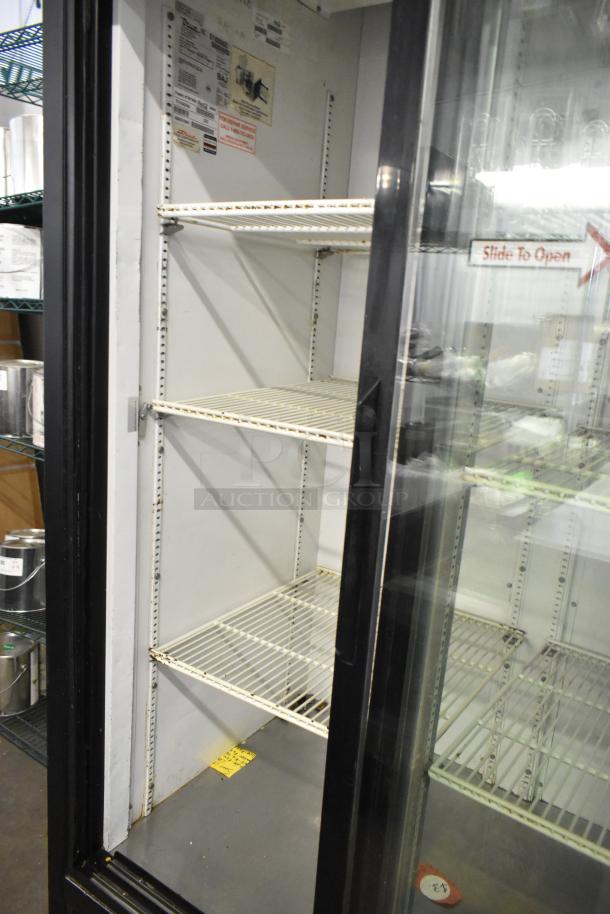 True GDM-37EM 2-door metal cooler merchandiser, poly-coated racks, 115V, 1-phase, good condition, interior tags visible.