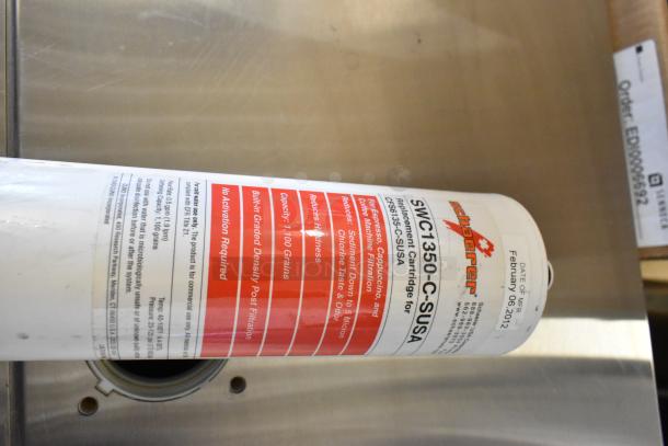 Six Schaerer SWC1350-C-SUSA water filter cartridges. Capacity: 1,100 grains. For coffee machine filtration. Date: February 06, 2012.