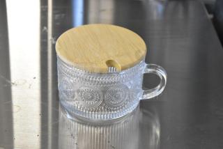Brand new glass mug with wooden lid, decorative pattern, clear handle, perfect condition. Part of a lot of 4.