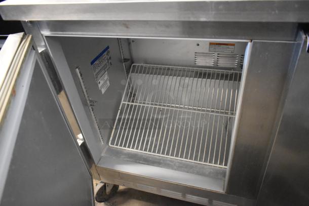 Beverage Air SP48-08 stainless steel sandwich prep table, commercial casters, 115 volts, 1 phase, open storage space visible.