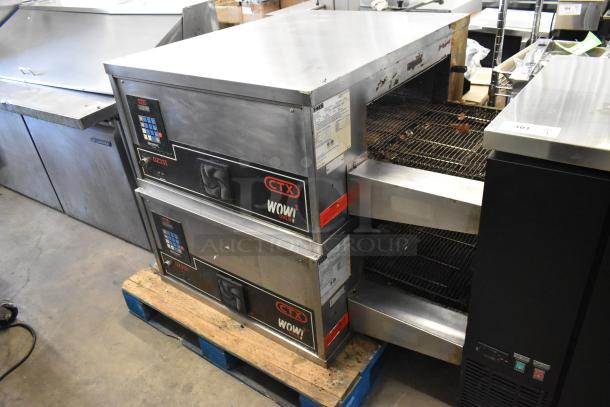Two 2021 Middleby Marshall DZ33I stainless steel conveyor pizza ovens, electric-powered, on commercial casters.