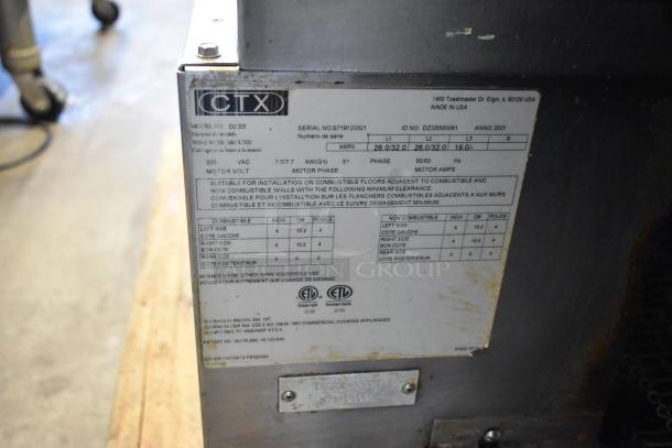 Middleby Marshall CTX DZ33I conveyor pizza oven label, stainless steel, 208V, commercial casters, serial details visible.