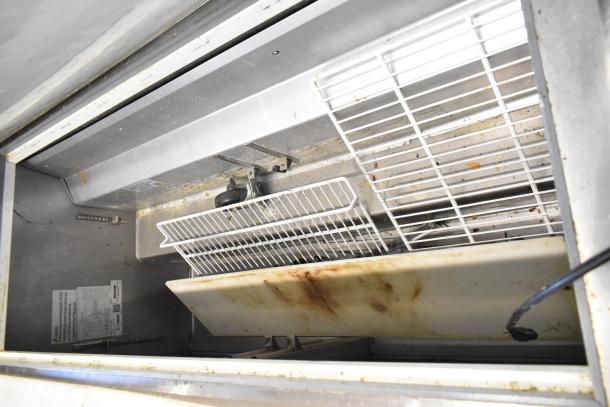 2023 Sir Lawrence SLMPREP-2DW stainless steel sandwich prep table, interior view, showing shelving and power label.