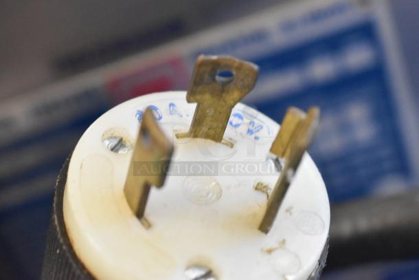Close-up of a plug for a Taylor 8752-27 commercial soft serve ice cream machine, showing a 208-230V, 1-phase connection.