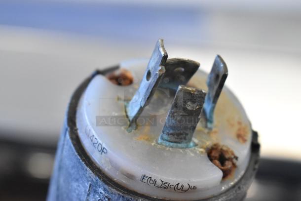 Close-up of worn plug on Hobart 4732 meat grinder. Plug shows signs of rust and wear. Markings visible, indicating model and certifications.
