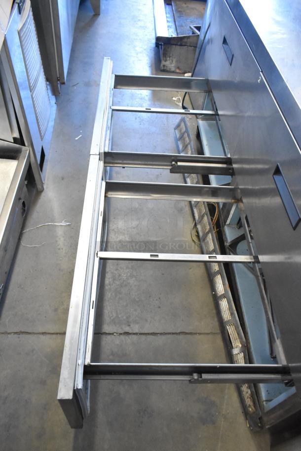 Delfield UCD4464N-12-DD5 stainless steel prep table, used, missing one lid, shown with four drawer frames.