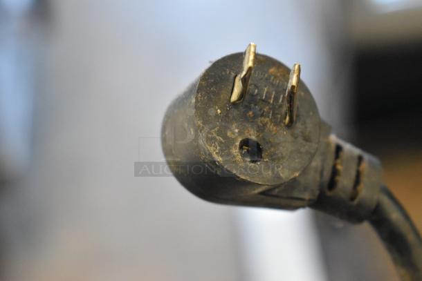 Close-up of a worn electrical plug for the Delfield UCD4464N-12-DD5 prep table. Connector shows signs of rust and wear.