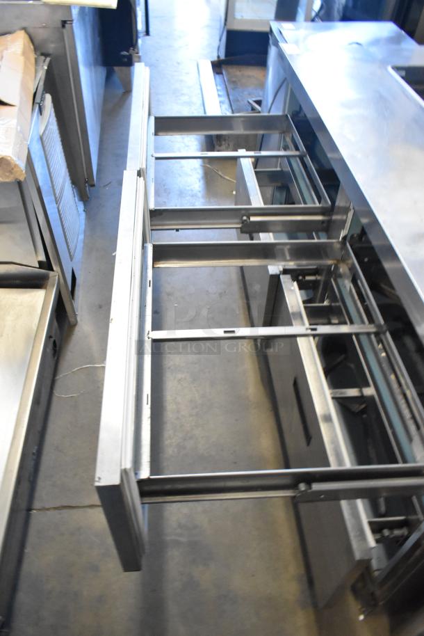 Delfield UCD4464N-12-DD5 stainless steel prep table with four open drawers, missing one lid. 115V, 1-phase.