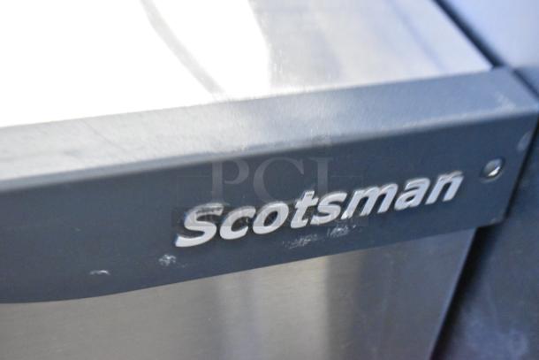 Scotsman C1030MA-32B Prodigy Plus stainless steel ice machine, 1077 lb capacity, logo visible, rugged condition.