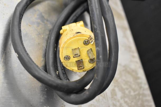 Yellow power plug with cable on stainless steel surface, part of Hoshizaki KM-280MWH ice machine, 115-120 volts, 1 phase.