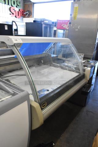 Lowe metal commercial deli display case merchandiser, large curved glass front, used condition, Lowe brand label visible.