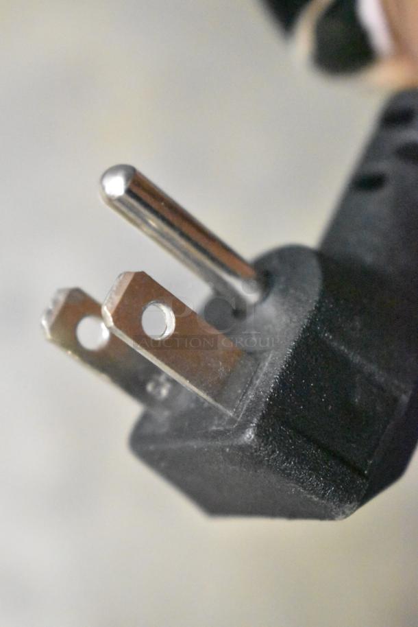 Close-up view of a standard three-prong electrical plug, part of the KoolMore KM-ICD-49SD ice cream dipping cabinet.