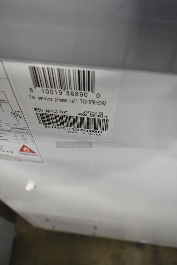 Brand new KoolMore KM-ICD-49SD ice cream dipping cabinet, 8 tub capacity, sliding glass doors, 115V, model details visible.