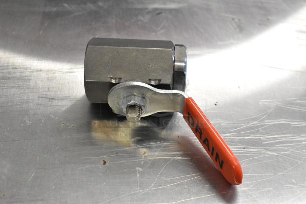 A metallic ball valve with a red handle labeled "DRAIN," in scratch-resistant condition.