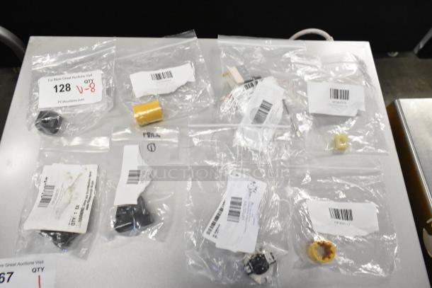 Eight new scratch and dent items in clear bags, including Lincoln parts, Cleveland switch, and Globe thermostat, with labels.
