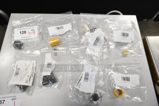Eight new scratch and dent items in clear bags, including Lincoln parts, Cleveland switch, and Globe thermostat, with labels.