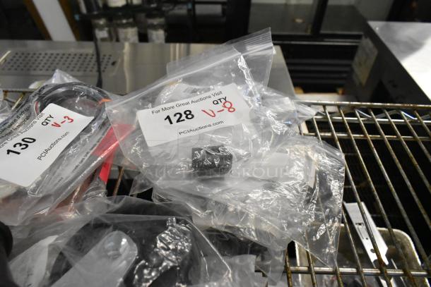 8 brand new packaged parts, including Lincoln sleeves and bearings, Cleveland and Giles switches, and Globe thermostat. Labels show "128 qty V-8" for identification.