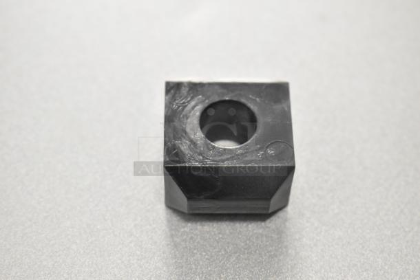 Black rubber bearing block, model Lincoln 369813, new condition. Square shape with central hole.