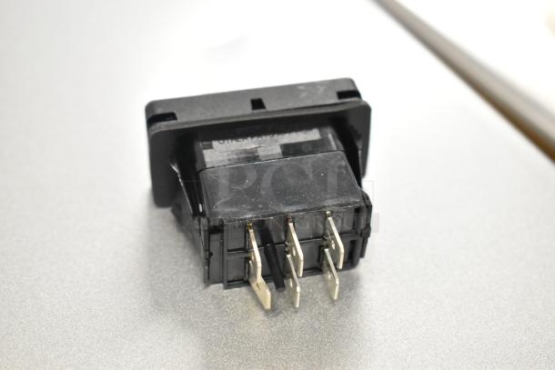 Black switch component with metal prongs, new condition, part of a lot including Lincoln models and others.