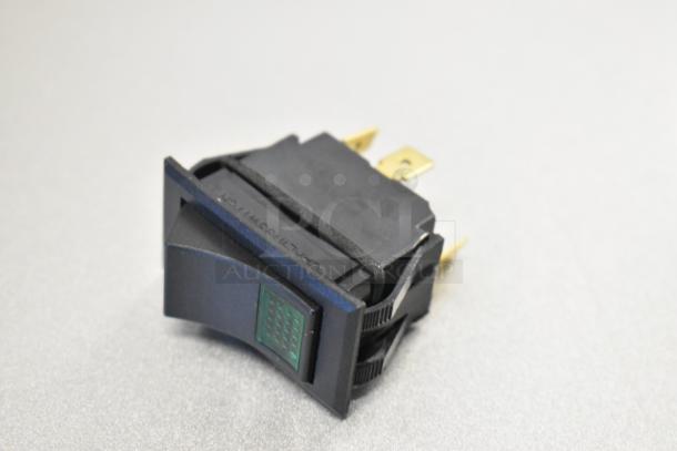 Lincoln 369805 lighted rocker switch, new condition, black with green indicator, part of 8-item auction lot.