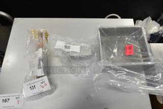 Three brand new kitchen items: Hatco R02.04.302.00 element, Giles 30206 drip cup, Shortening Shuttle SP-BS-100. Wrapped and labeled.