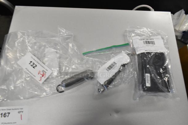 Three new scratch and dent parts: Garland oven door spring, ignition module kit, Southbend oven door spring in packaging.