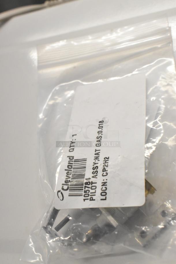 Bag containing Cleveland 105784 Pilot Assembly; Nat Gas 0.018. New condition with visible label and part number.