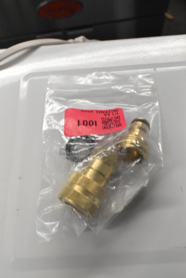 5-piece auction lot, featuring a Regency 600QDSN 3/4" quick-disconnect spray nozzle adapter. Packaged with a red tag marked "1001."