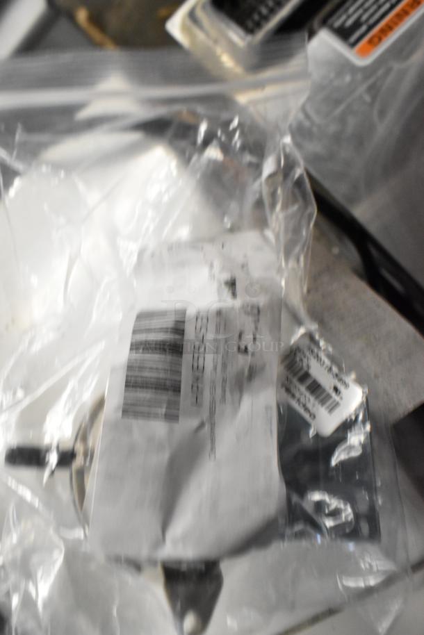 Six brand new scratch and dent items in clear packaging, including various relays and switches with visible labels and barcodes.