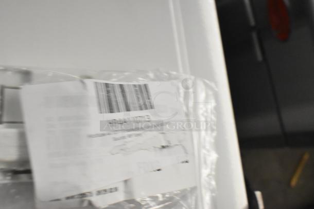 Plastic-wrapped new relay with a visible barcode and partial label. Auction lot includes six brand new, scratch and dent items.