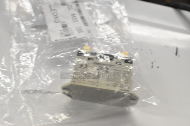 Package containing a new relay component with visible labeling and part numbers, in sealed condition.