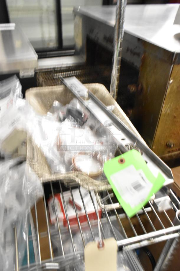 Assorted new scratch and dent items, including Imperial burner hanger, Blodgett thermocouples, Cleveland igniter cable, in plastic wrap.