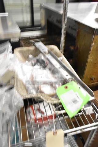 Assorted new scratch and dent items, including Imperial burner hanger, Blodgett thermocouples, Cleveland igniter cable, in plastic wrap.