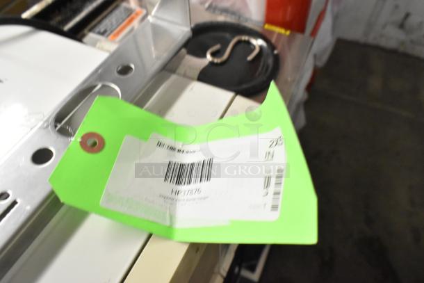 Green tag attached to metal burner hanger, labeled "Imperial 37876 HP37876," with barcodes and item details.