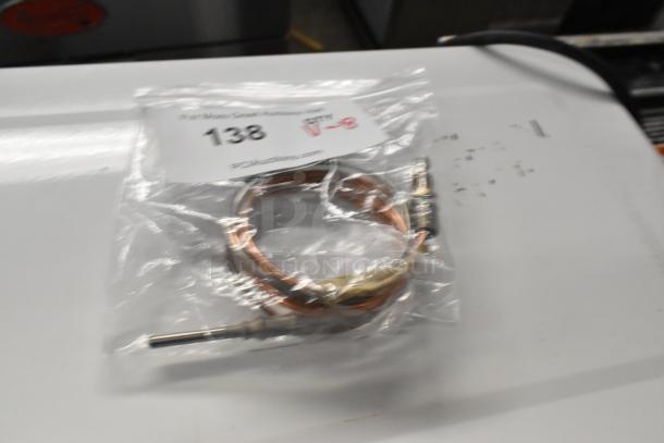 Bagged thermocouple with label "138" and website text, part of an 8-item scratch and dent auction lot.