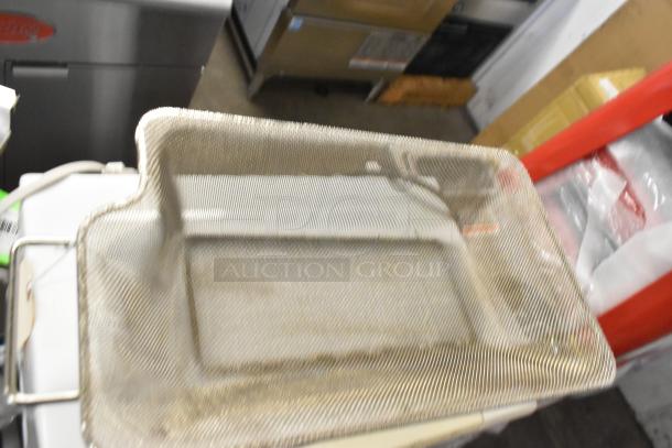Metal mesh fryer basket with rectangular shape and handle on the left. Slightly worn appearance.