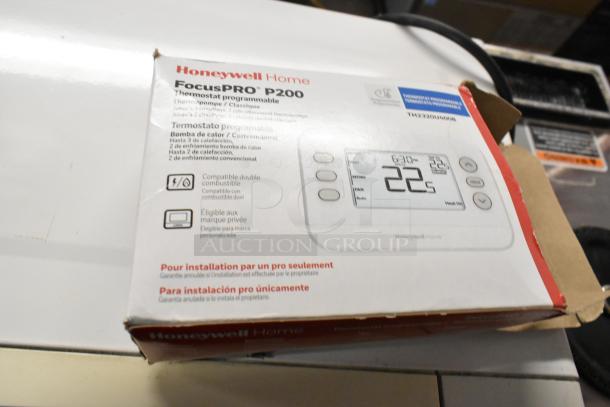 Honeywell Home FocusPRO P200 thermostat box, model 92B2320U4006, new condition, dual fuel compatible.